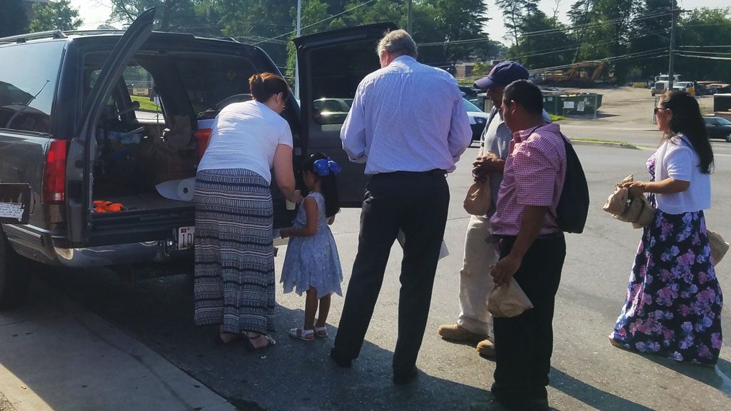 tim lale and veronica carrera serve food to our local migrant population in Silver Spring, Maryland