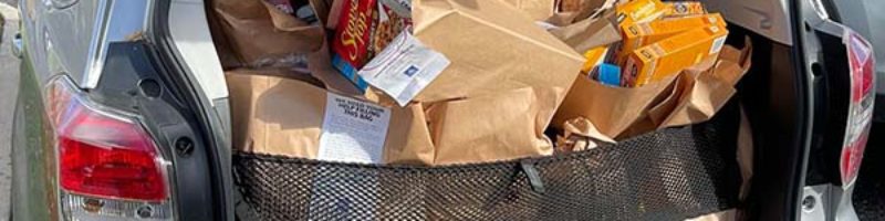 thanksgiving food drive bags packed into the back of an suv