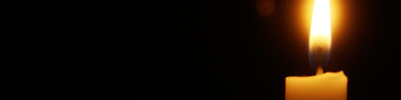 candle burning in a dark room