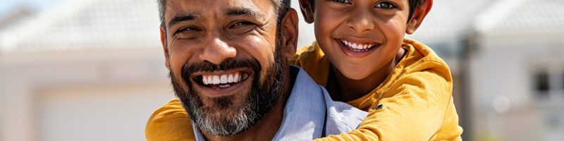 southern asian father and son smiling and laughing together
