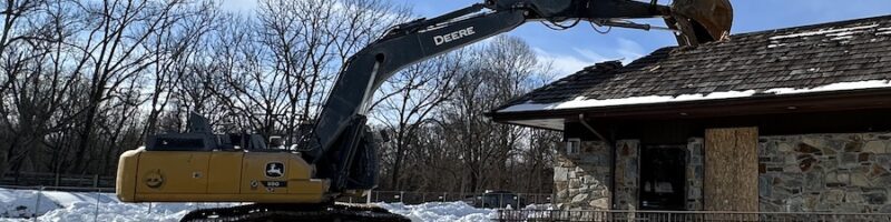 An excavator beginning to tear down the building at Spencerville Church.