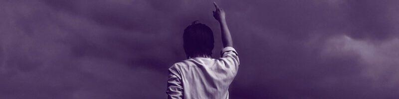 man pointing his finger to the sky talking to God